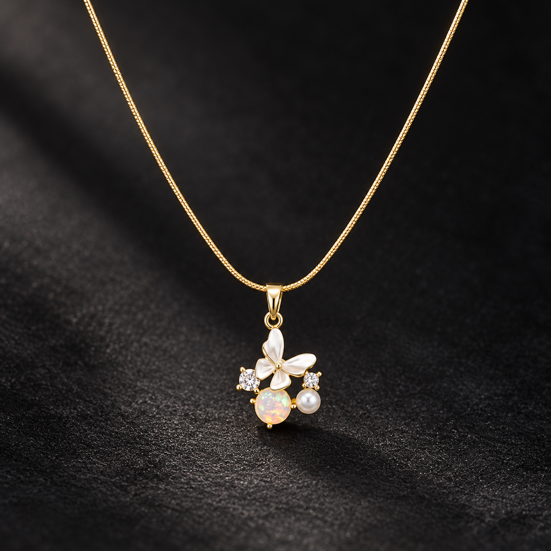 Gold-tone 316L stainless steel snake chain necklace with a butterfly pendant set with white enamel, opal and pearl