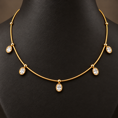 Gold-tone 304 stainless steel necklace with a fine chain, five oval white stones in beaded settings and ball spacers, worn on a neck