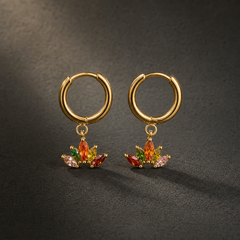 Two earrings of one design, each a small yellow-gold-tone hoop with a polished finish and a huggie-hinge hoop closure; the hoop wire is slender gauge. From each hoop a single charm section hangs on a small jump ring, giving two articulated sections per earring, hinging at the jump ring. Overall drop is approximately one-and-a-half times the hoop diameter. Each charm is a solid-metal fan mounting a cluster of marquise-cut elements in red, orange, green and pink-to-clear tones, individually prong-set.
