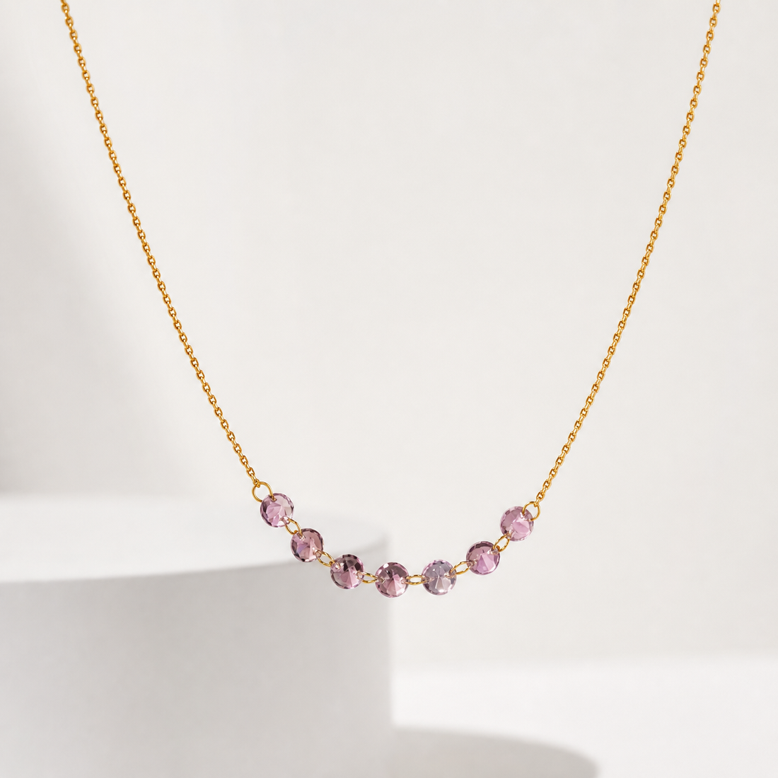 One necklace in yellow gold-tone metal with a polished finish. Construction is a single fine-gauge twisted rope-style chain; the strand continues beyond the frame at both ends, so the closure and any extender or terminal tag are not visible. The chain run is approximately 90 times the width of the largest bead component.