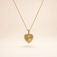 A single yellow gold-tone necklace with a polished finish, comprising one continuous fine-gauge cable-chain strand with small oval links and a single pendant drop. The chain run is approximately 25 times the width of the pendant. The clasp end and any extender are partly obscured; no working closure or terminal tag is visible in what can be seen, so no extender fraction can be stated.