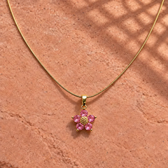 Gold-tone 316L stainless steel pendant necklace with a five-petal flower of pink stones and a gold-tone centre
