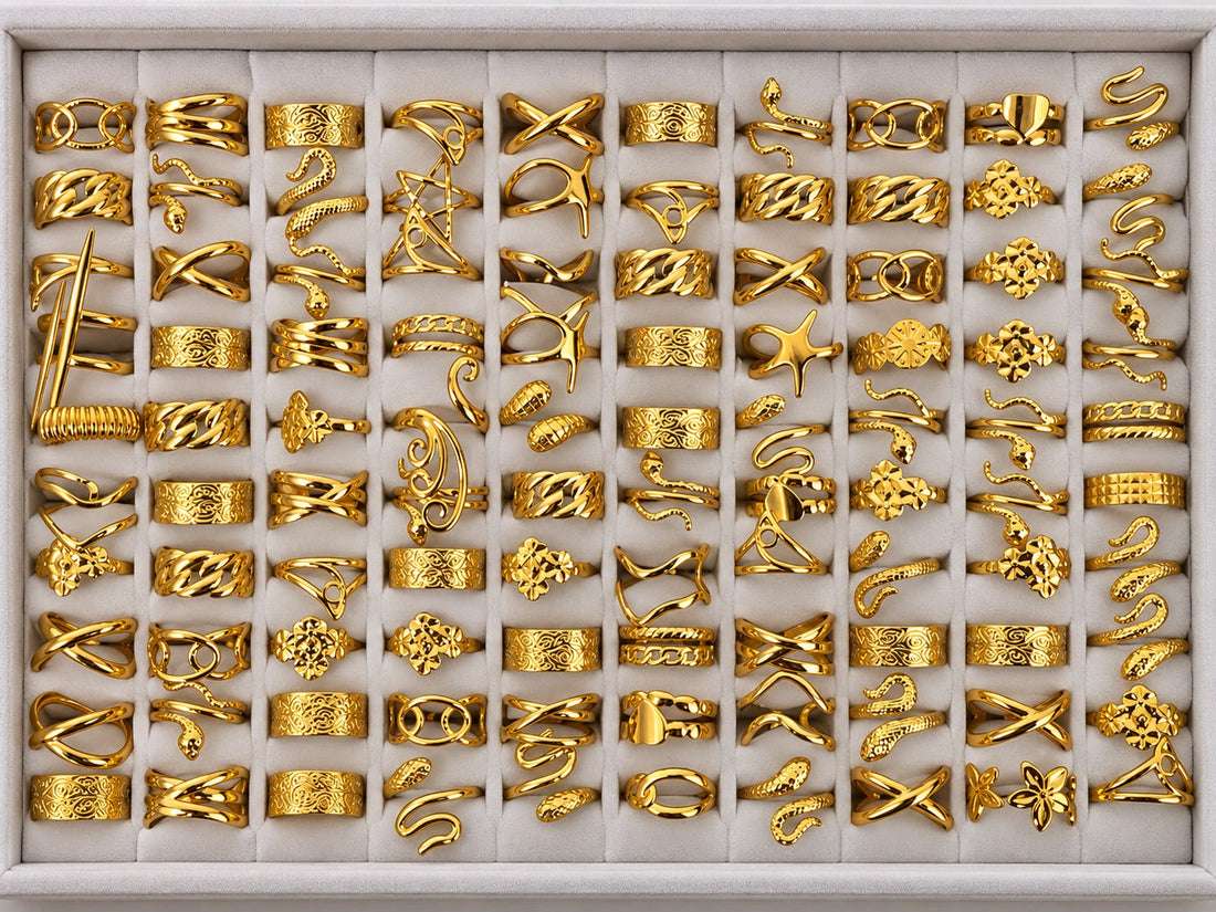 Gold-tone 304 stainless steel rings in a set of 50 with assorted bands, twists and open designs, displayed in a tray