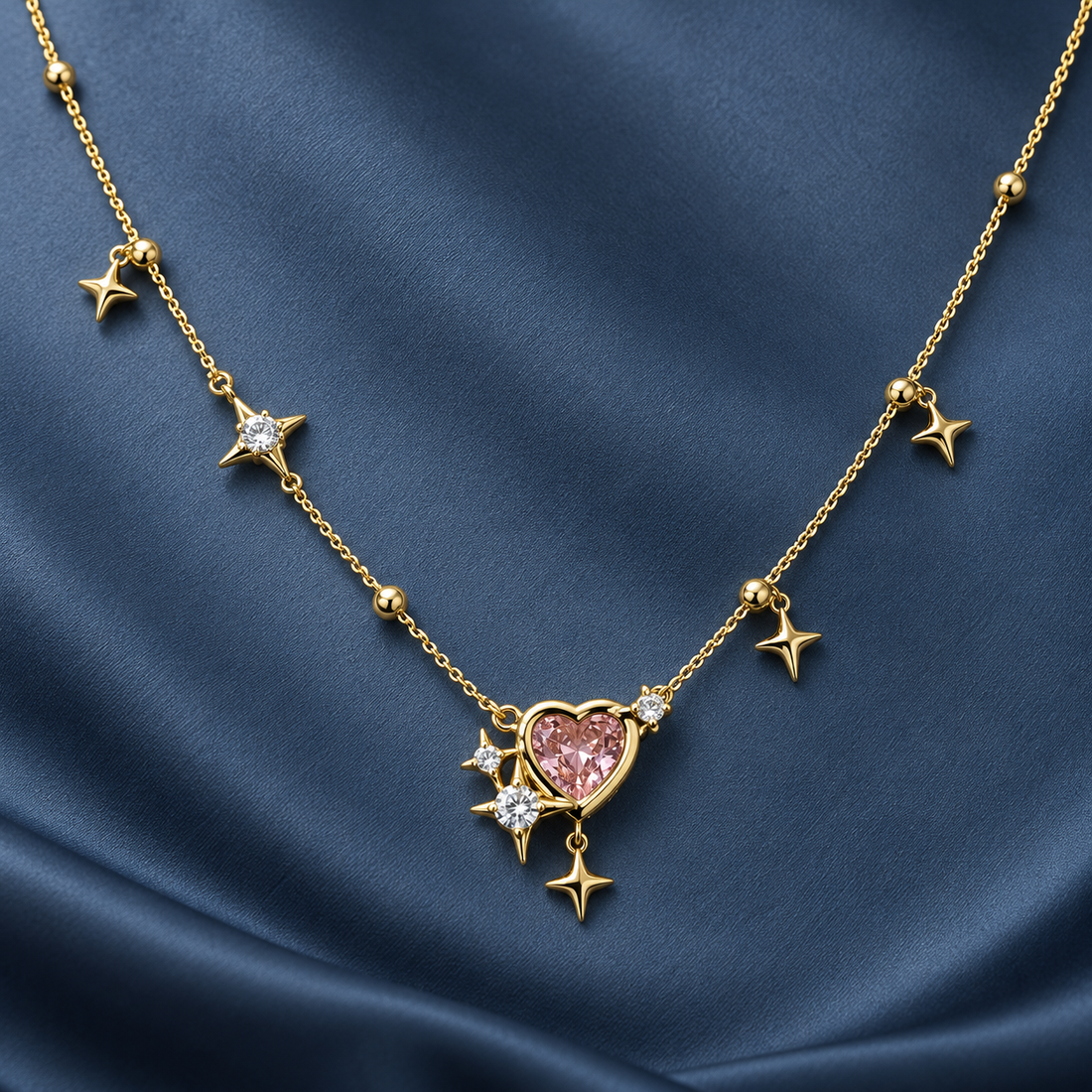 Gold-tone 316L stainless steel necklace with a pink heart stone pendant, star charms and clear crystal accents on a fine chain