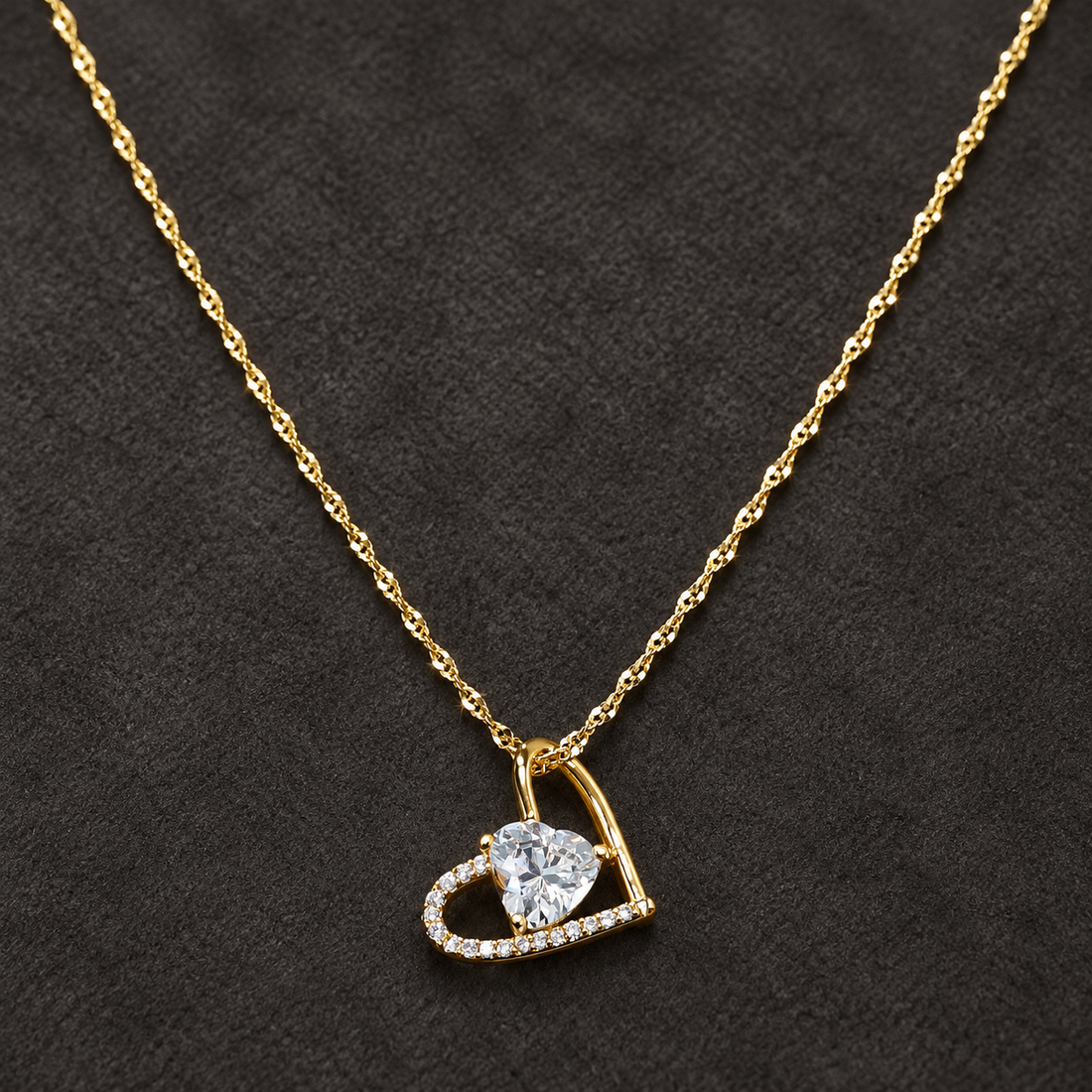 Gold-tone 316L stainless steel heart pendant necklace with a clear crystal heart centre and pavé outline on a twisted chain