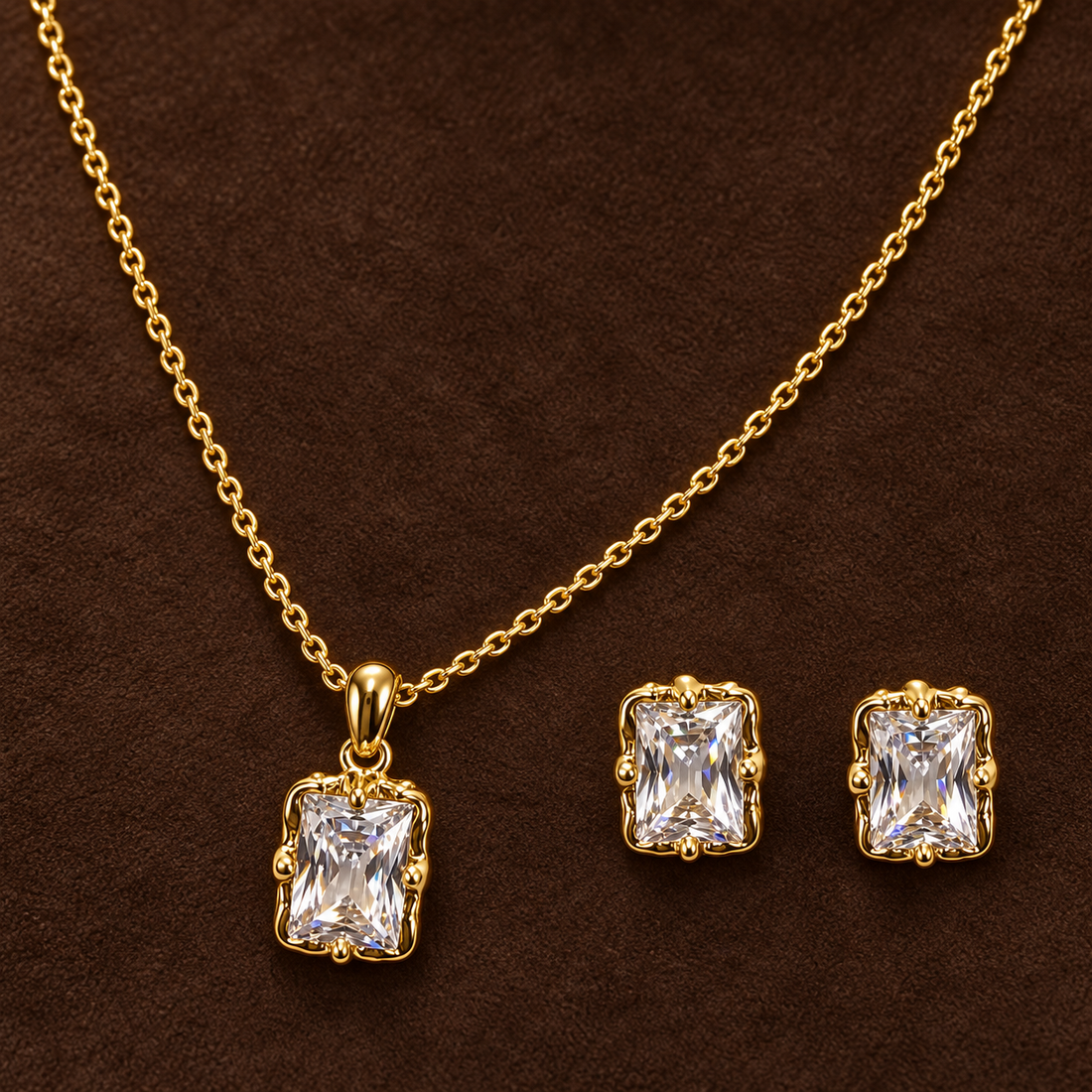 Gold-tone 316L stainless steel necklace and earring set with a clear rectangular stone pendant and matching stud earrings