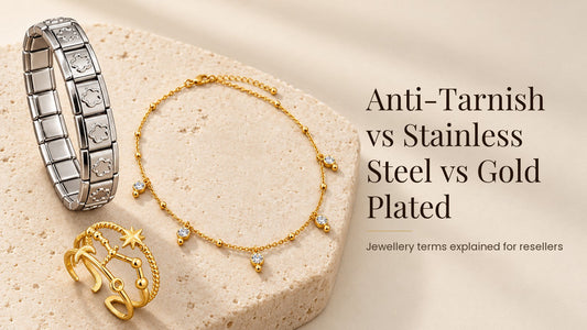 Anti-Tarnish vs Stainless Steel vs Gold Plated. Silver-tone steel bracelet, gold-tone necklace and ring on a pale cream stone slab
