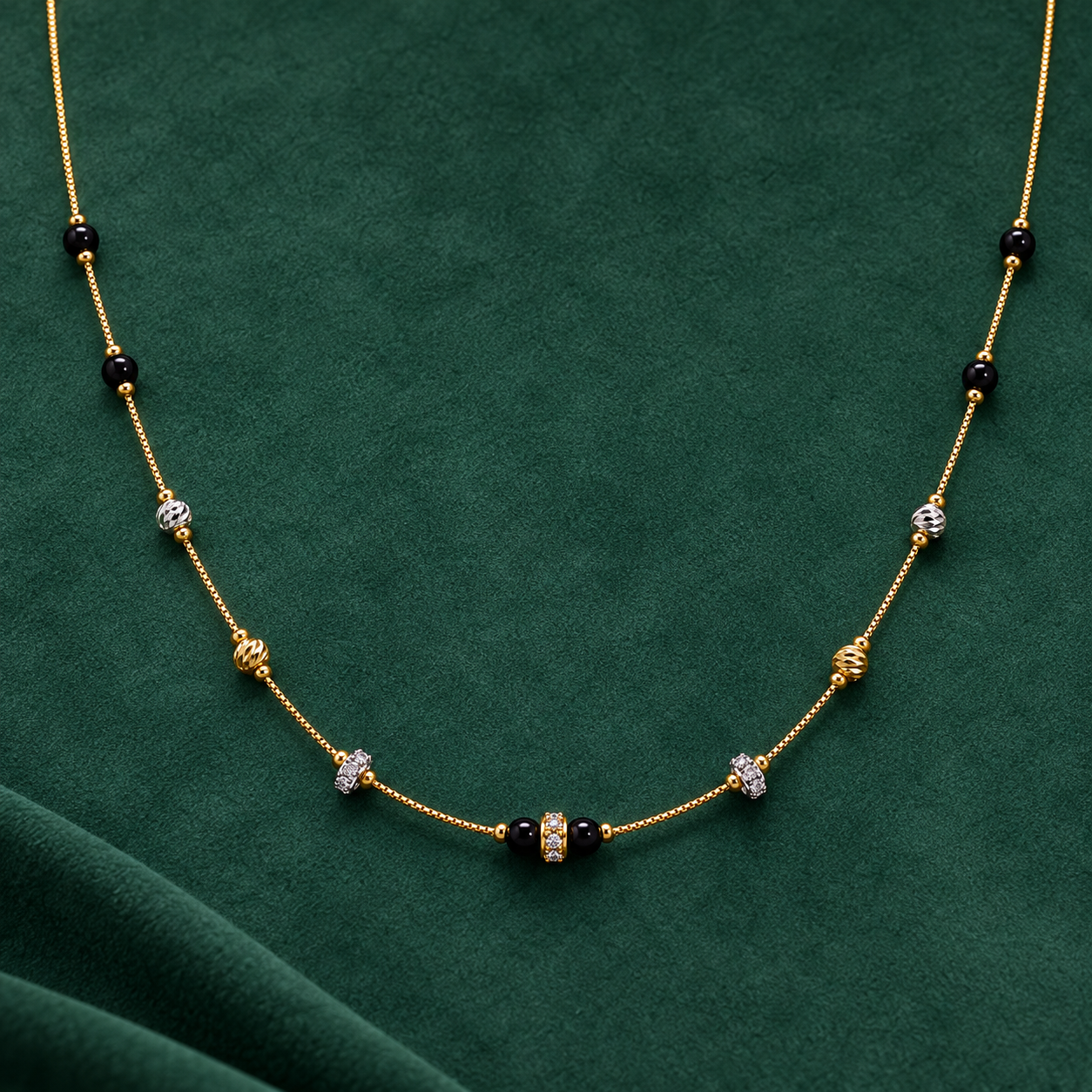 Gold-tone 316L stainless steel necklace with black beads, textured gold and silver-tone spacers and crystal-set rondelles on a fine chain