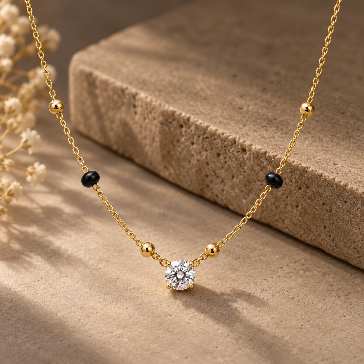 Gold-tone 316L stainless steel necklace with a single round crystal pendant on a fine chain with black and gold beads