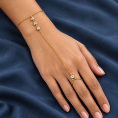 Gold-tone 304 stainless steel hand chain bracelet with clear crystal-set bezels on a wrist chain and a ring on the middle finger, worn on a hand