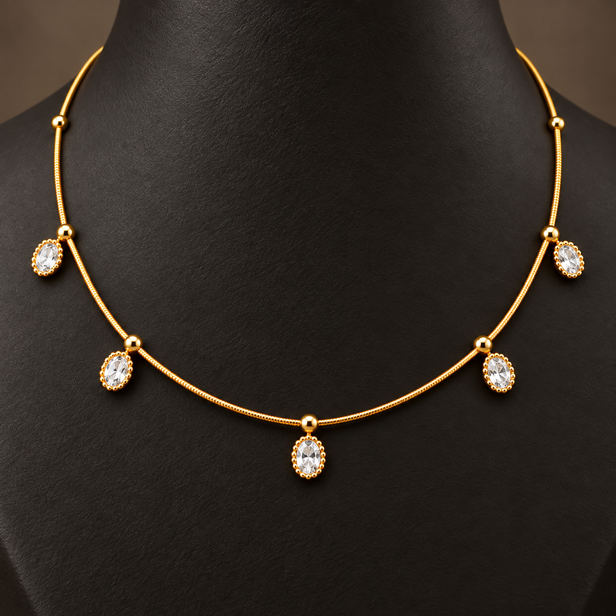 Gold-tone 304 stainless steel necklace with a fine chain, five oval white stones in beaded settings and ball spacers, worn on a neck