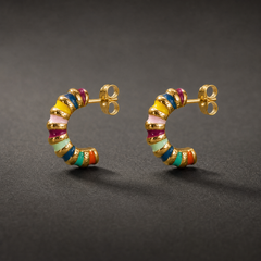 Two ear-worn earrings, a pair of small half-hoop (J-hoop) studs in gold-tone metal with a polished finish. Each fits with a post and butterfly back, the post slim and standard gauge, roughly one and a half times the hoop's width in length. Overall drop is approximately one and a half times the widest point of the hoop.