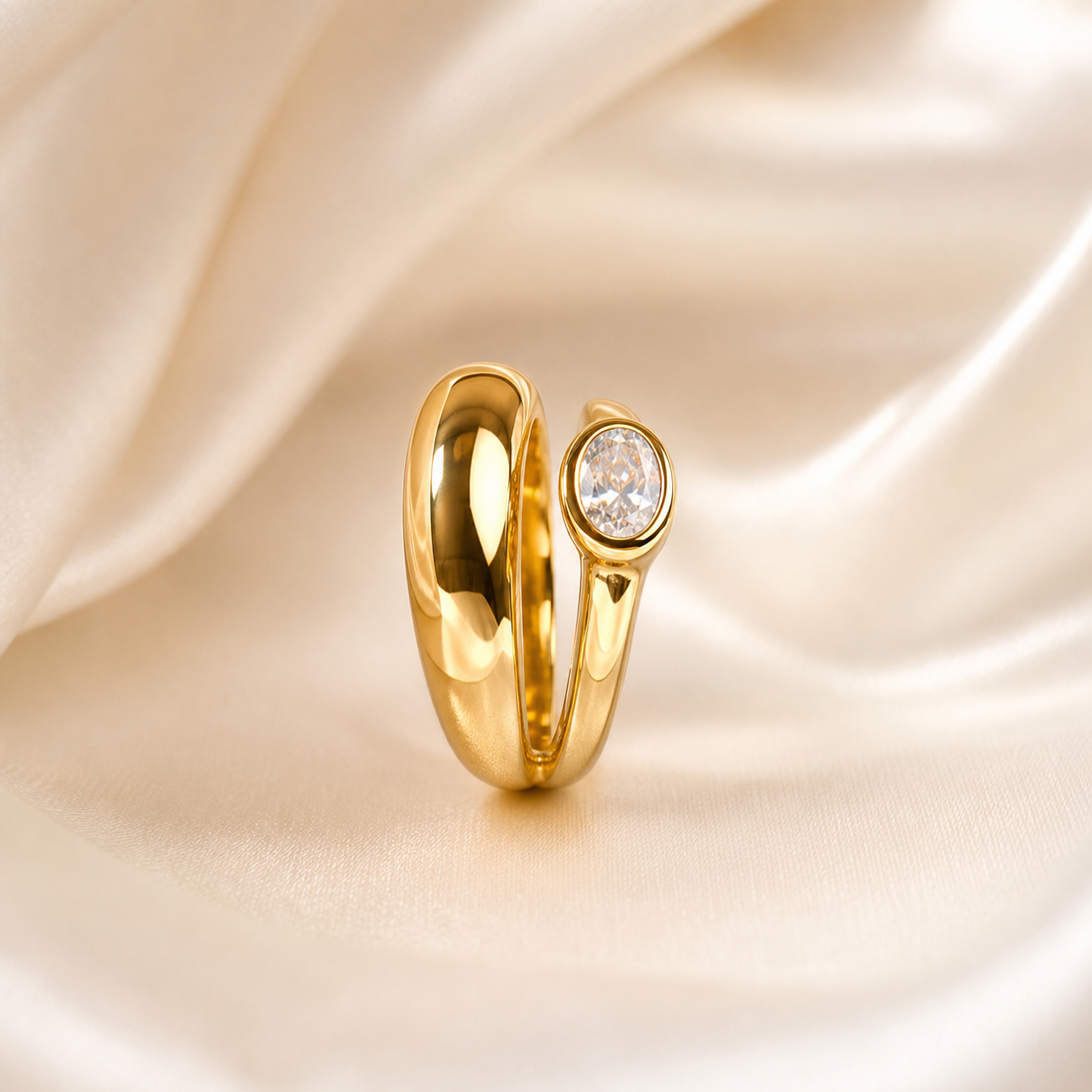 A single ring in yellow-gold-toned metal with a high-polish, mirror-bright finish. The band is a solid, rounded, wide-profile shank of uniform domed cross-section that splits asymmetrically at the crown: one shoulder swells into a broad, smooth, tapering lobe of plain polished metal, while the other shoulder narrows and rises to carry the single stone.
