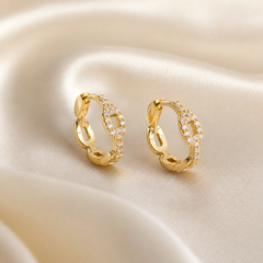 A matched pair of small hoop (huggie) earrings, two items total. Yellow-gold-coloured metal with a polished finish. Each earring is a narrow circular hoop built as a continuous band of rounded, slightly elongated open chain-link-style segments, giving a scalloped, undulating outline; the links are cast solid metal, not actual movable chain.