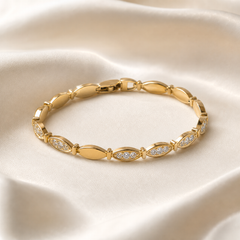 A single yellow-gold bracelet of polished finish, built as an articulated single strand of identical elongated marquise-shaped (pointed-oval) solid links joined end to end by small bar connectors. Some links are plain polished hollow-appearing marquise forms, while others carry a recessed pavé field of small round colourless clear faceted stones set flush into the gold surface; these two link types alternate in an irregular sequence around the strand, with consecutive stone-set links occurring at one