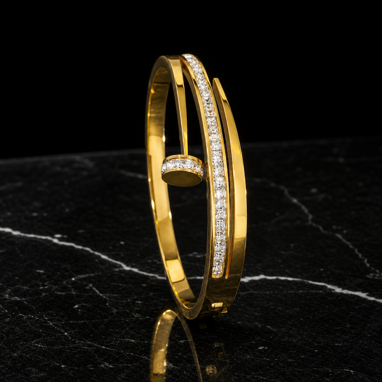 A single rigid bangle in polished yellow gold, high-shine finish. The band is a flat cross-section strip roughly one-twentieth of the outer diameter in width, even all the way round with no swelling. It is an open cuff: the band ends overlap and cross past each other, leaving a gap approximately equal to the band width, with one end terminating in a round flat disc end cap edged with small round colourless stones in a pavé-style setting.