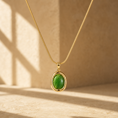 One necklace in yellow-gold-tone metal with a polished finish. Construction is a single fine snake-chain strand of narrow, tight weave, running to a single pendant bail; the chain run is approximately 25 times the width of the pendant, the largest component. No clasp, extender or terminal tag is visible in the frame, so closure type and extender length cannot be confirmed; both ends of the chain exit the view unresolved.