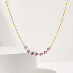 One necklace in yellow gold-tone metal with a polished finish. Construction is a single fine-gauge twisted rope-style chain; the strand continues beyond the frame at both ends, so the closure and any extender or terminal tag are not visible. The chain run is approximately 90 times the width of the largest bead component.