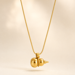 One necklace in polished yellow-gold-tone metal with a high-shine finish. It is built on a single fine snake chain of narrow, tight gauge forming one continuous strand; the clasp end is not visible in the frame, so no closure, extender or terminal tag can be confirmed, and no extender chain is seen. The visible chain run measures roughly twenty to twenty-five times the width of the largest component.