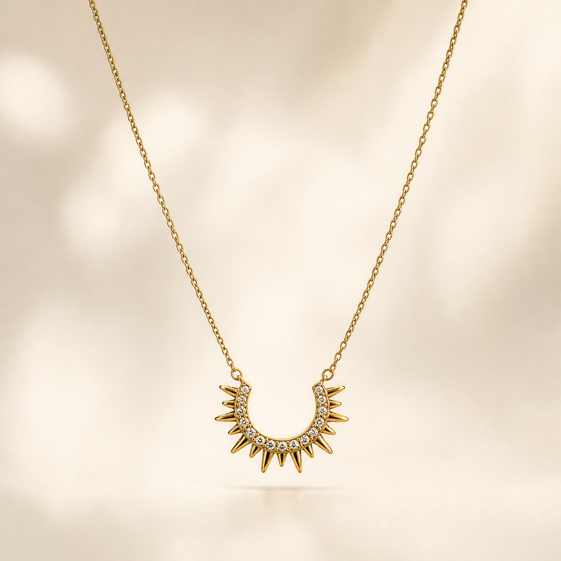 A single necklace in gold-tone metal with a polished finish, built from one fine-gauge cable chain forming a single continuous strand. The chain run is roughly fifteen times the width of the largest component; no extender is visible, so no extender fraction can be given, and no working clasp or terminal tag is visible (the closure area is partly obscured).