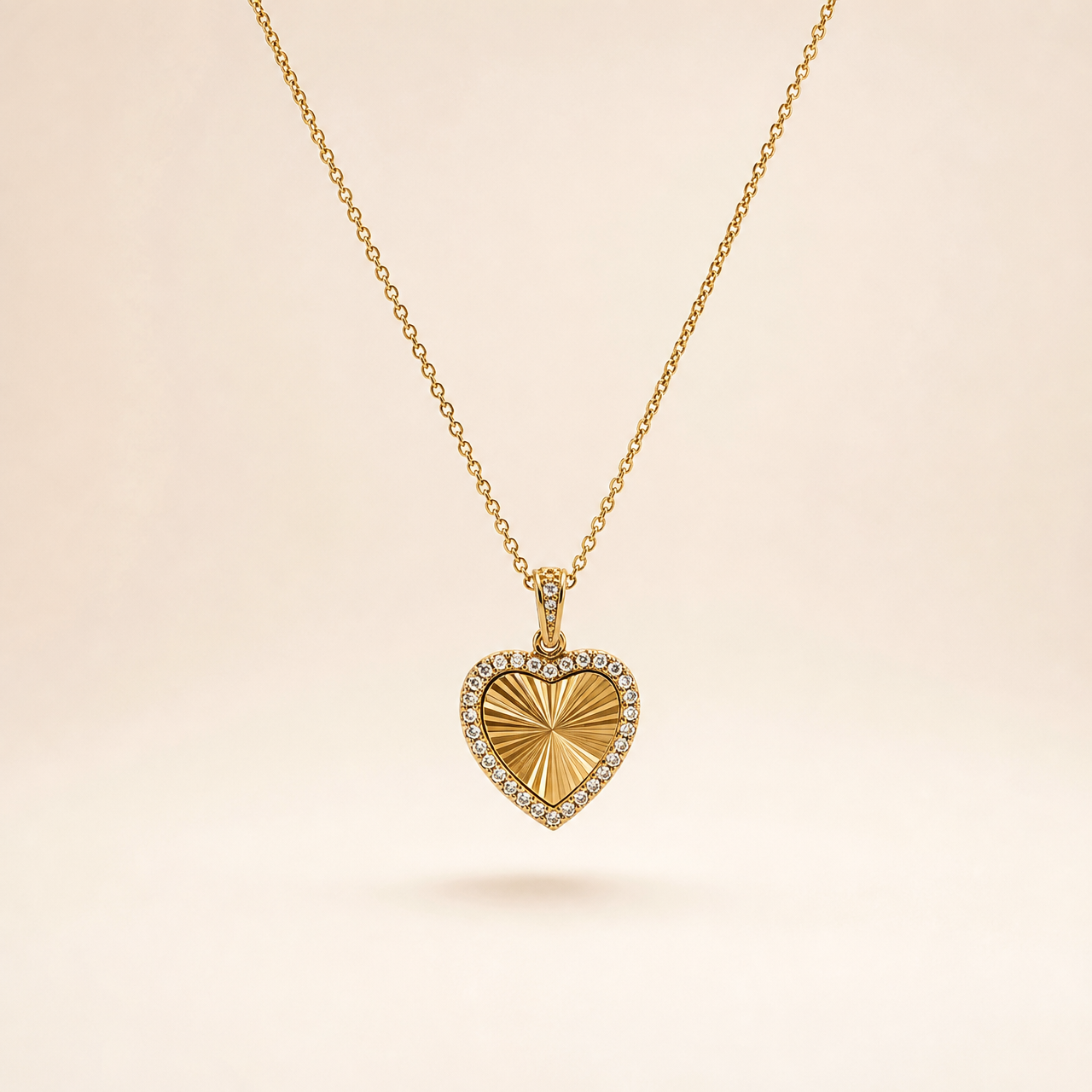 A single yellow gold-tone necklace with a polished finish, comprising one continuous fine-gauge cable-chain strand with small oval links and a single pendant drop. The chain run is approximately 25 times the width of the pendant. The clasp end and any extender are partly obscured; no working closure or terminal tag is visible in what can be seen, so no extender fraction can be stated.