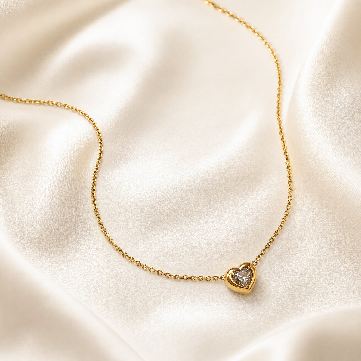 One necklace comprising a single continuous strand of fine-gauge gold-tone cable chain with small oval links and a polished yellow-metal finish, laid open across the frame with both ends running out of view, so the clasp, extender and any terminal tags are not visible and cannot be counted.