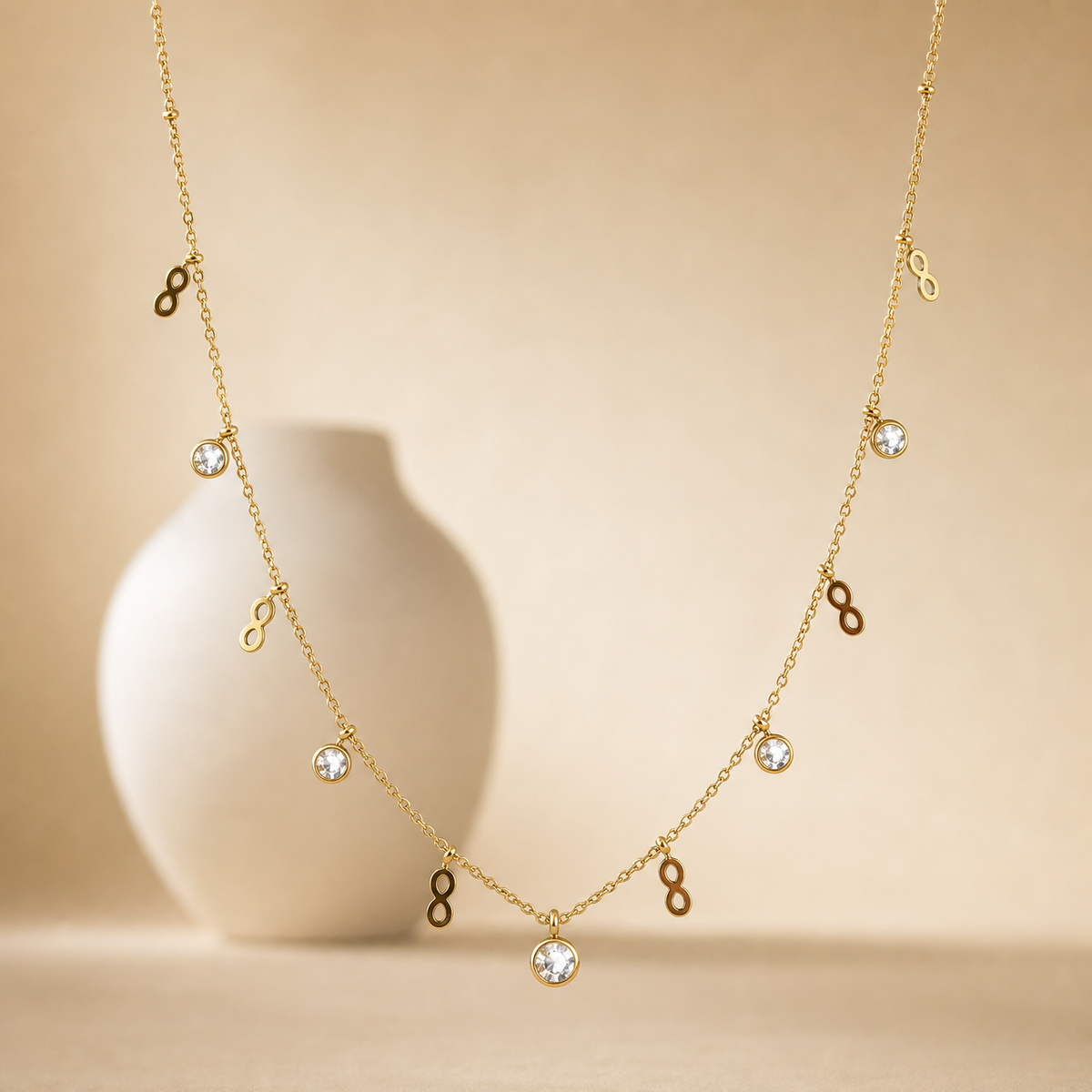 One necklace, yellow-gold in colour with a polished finish, built as a single fine cable chain of small gauge links with tiny bead accents at intervals. The chain run measures roughly 40 times the width of the largest component; no extender chain is visible, so no extender fraction can be stated, and no working clasp is visible in view.