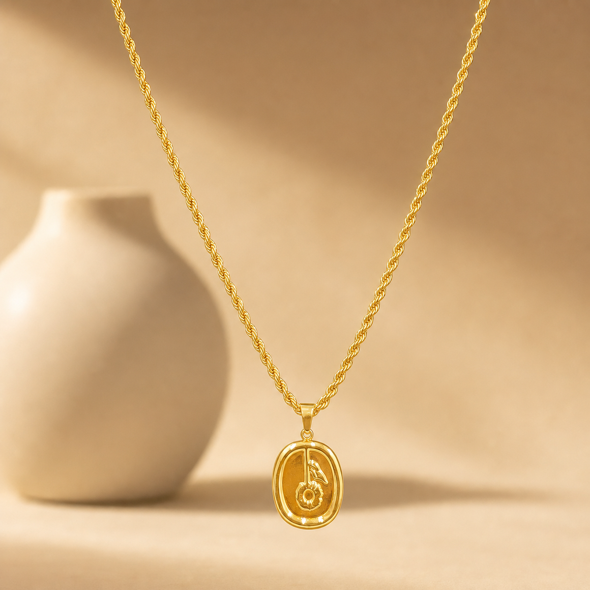 One necklace, a single strand of yellow-gold-colour metal with a polished, bright finish. The chain is a twisted rope chain of medium-fine gauge, one continuous strand with no branches. Its total run is approximately 25 times the width of the pendant, the largest component; no extender chain is visible, so no extender fraction can be stated. No working closure is visible in the image; the clasp area is partly obscured.