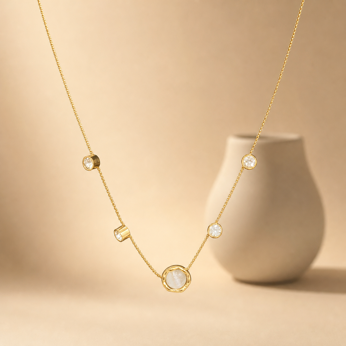 One necklace, gold-tone metal with a polished finish. It is a single fine strand of small round cable/curb-style links, light gauge, with no branches; the visible chain run is approximately 50 times the width of the largest component, and no extender is visible (0× the main chain). No working closure, clasp, extender chain, or terminal tag is visible.