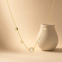 One necklace, gold-tone metal with a polished finish. It is a single fine strand of small round cable/curb-style links, light gauge, with no branches; the visible chain run is approximately 50 times the width of the largest component, and no extender is visible (0× the main chain). No working closure, clasp, extender chain, or terminal tag is visible.