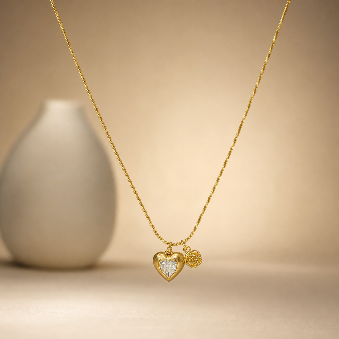 One gold-tone necklace with a polished yellow-metal finish, built as a single continuous strand of fine twisted rope chain with a narrow, uniform link gauge and no branches. The chain run is approximately thirty times the width of the largest component, the heart pendant; no extender chain is visible, so no extender fraction can be given, and no working clasp is visible as the closure area is partly obscured.
