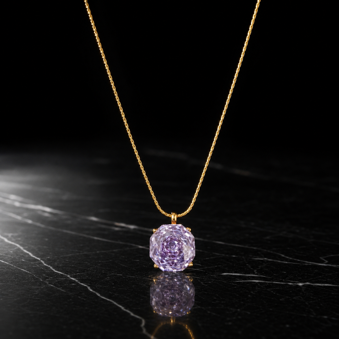 One single-strand pendant necklace in yellow-gold-coloured metal with a bright polished finish. The chain is a fine, tightly woven round chain (wheat/snake-like links of small, even gauge) with no branches; its total run is roughly 35-40 times the width of the pendant stone. No clasp, extender chain or terminal tag is visible; both ends of the chain run out of view, so closure type cannot be confirmed and no extender length can be stated.