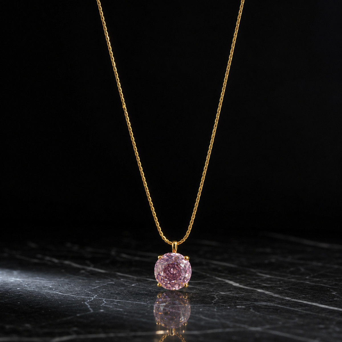 A single necklace in yellow-gold-tone metal with a polished finish, built as one continuous fine chain of a tight, round braided (snake or foxtail) type with small-gauge links and no branches. The visible chain run is roughly 25 to 30 times the width of the pendant stone; the far end of the chain exits the frame, so no working closure, clasp, extender or terminal tag is visible, and no extender fraction can be measured.