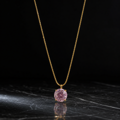 A single necklace in yellow-gold-tone metal with a polished finish, built as one continuous fine chain of a tight, round braided (snake or foxtail) type with small-gauge links and no branches. The visible chain run is roughly 25 to 30 times the width of the pendant stone; the far end of the chain exits the frame, so no working closure, clasp, extender or terminal tag is visible, and no extender fraction can be measured.