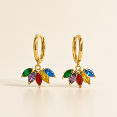Two earrings, one design: gold-tone metal with polished finish. Each is a small hinged huggie hoop fitting, roughly 12 mm in diameter with a slim gauge, opening at the bottom of the hoop. From the hoop's base hangs a single articulated section: a cluster of five marquise-cut faceted stones in gold-tone prong settings joined to the hoop by a small jump ring. The stones run green, purple, red, yellow and blue, each of similar size and pointed-oval shape. Total drop is about twice the hoop width.