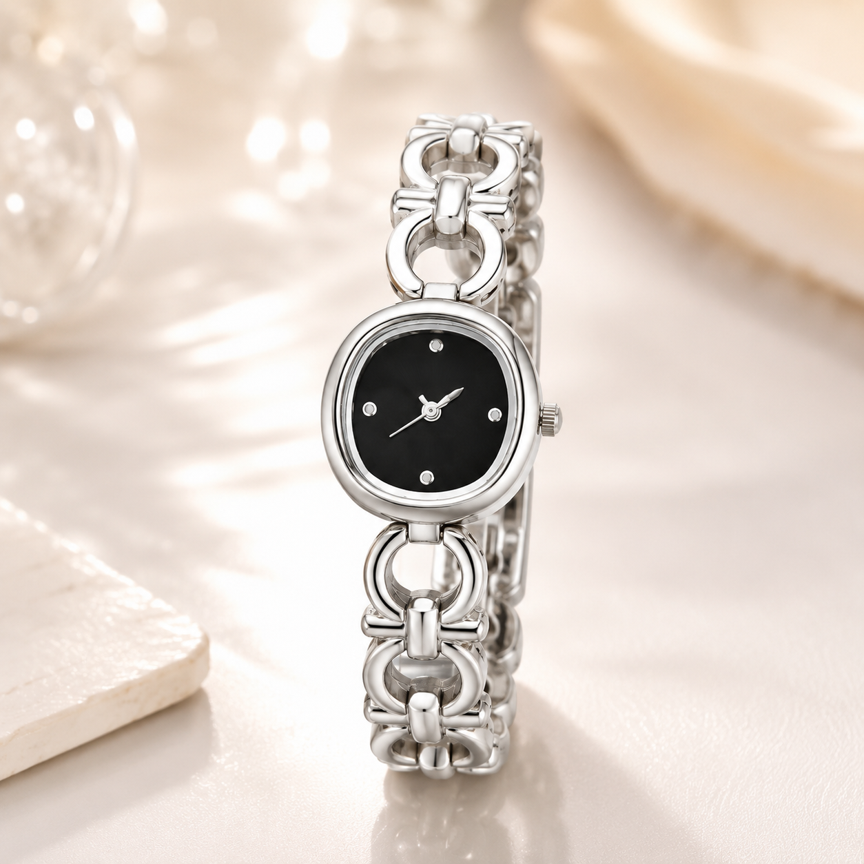 Silver-tone 316L stainless steel wristwatch with a black dial, six stone markers and an interlocking link bracelet, shown front-on