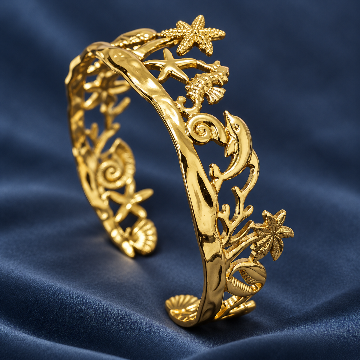 Gold-tone 304 stainless steel cuff bracelet with sea-motif cutouts of starfish, seahorse, dolphin and shells