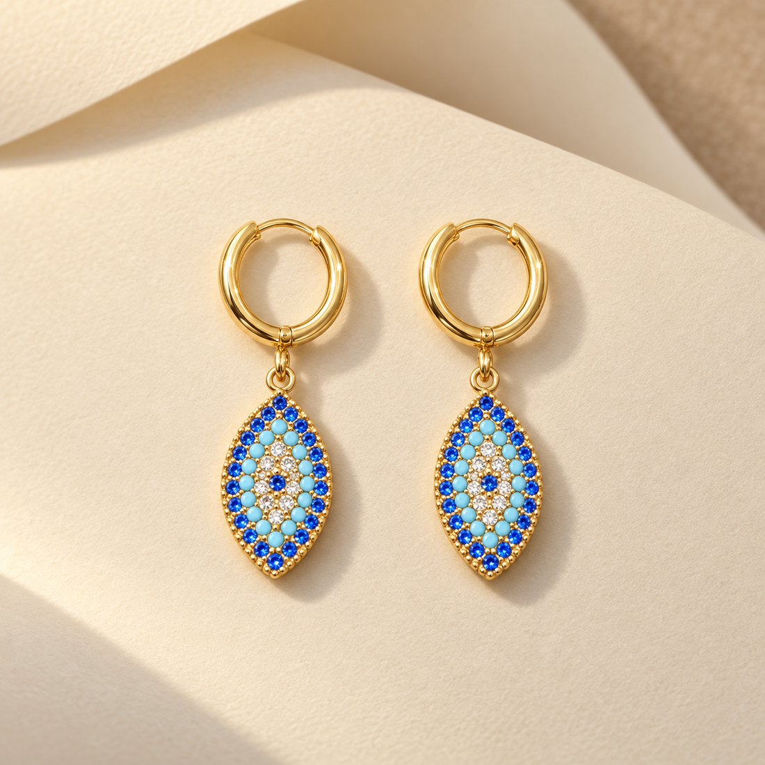Gold-tone 316L stainless steel huggie hoop earrings with marquise evil eye drop pendants set with blue, turquoise and white stones