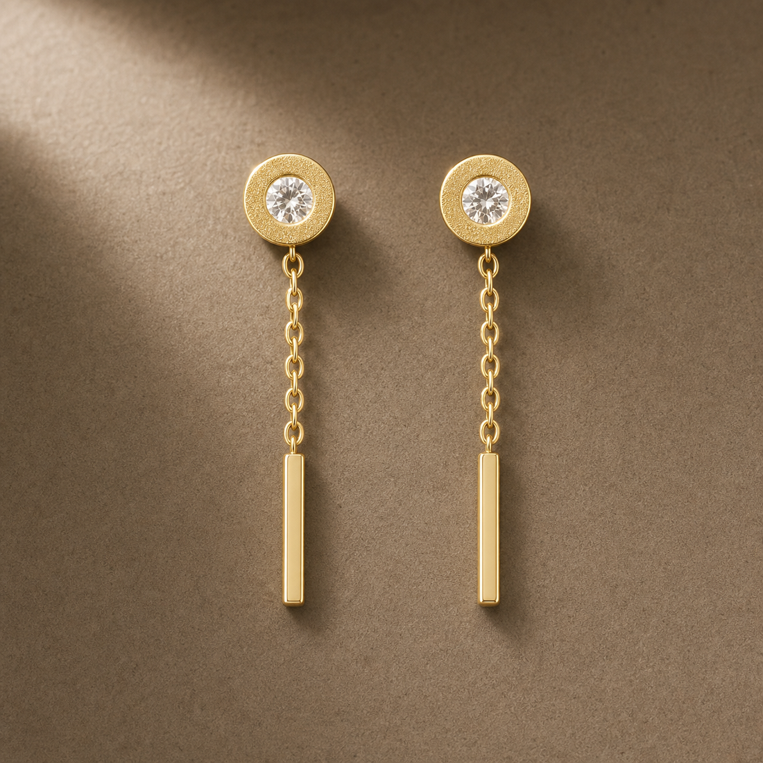 Gold-tone 304 stainless steel drop earrings with a round clear-stone stud top, a fine chain and a straight bar drop, shown as a pair