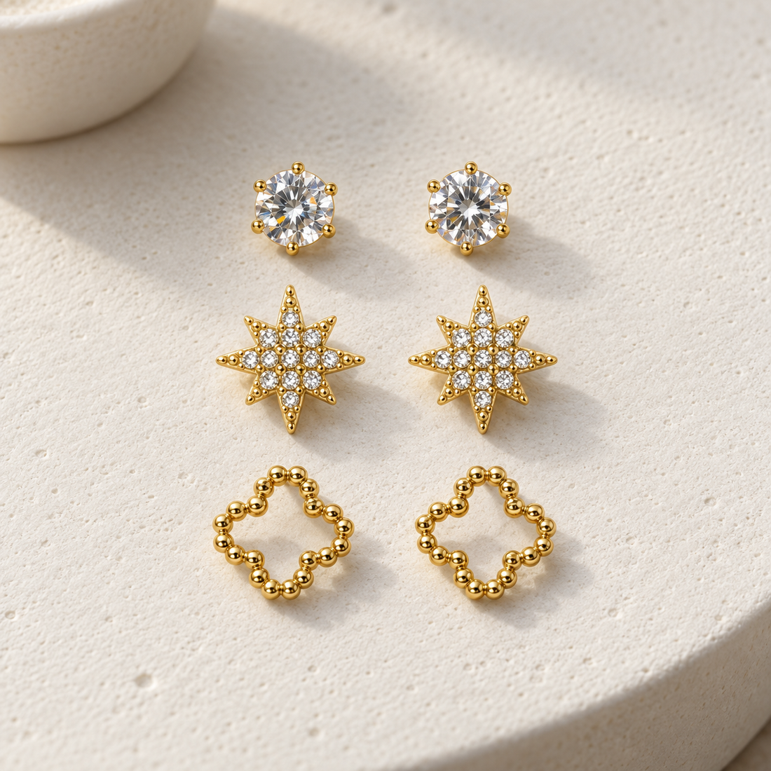 Gold-tone 316L stainless steel stud earring set: round crystal, cubic star and beaded clover, three pairs