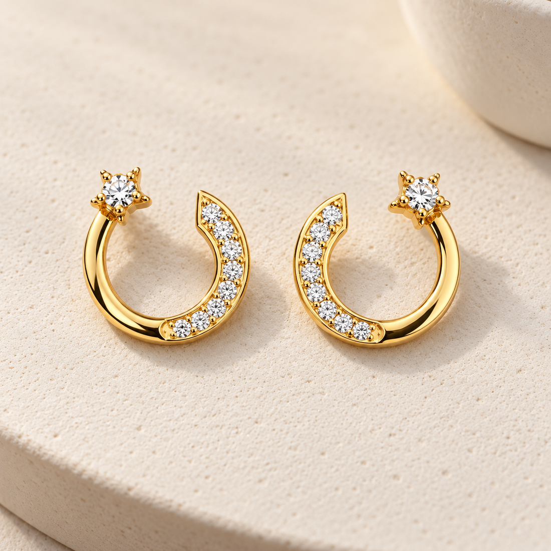 Gold-tone 304 stainless steel crescent moon earrings with clear crystal pavé and a star-set stud, a pair