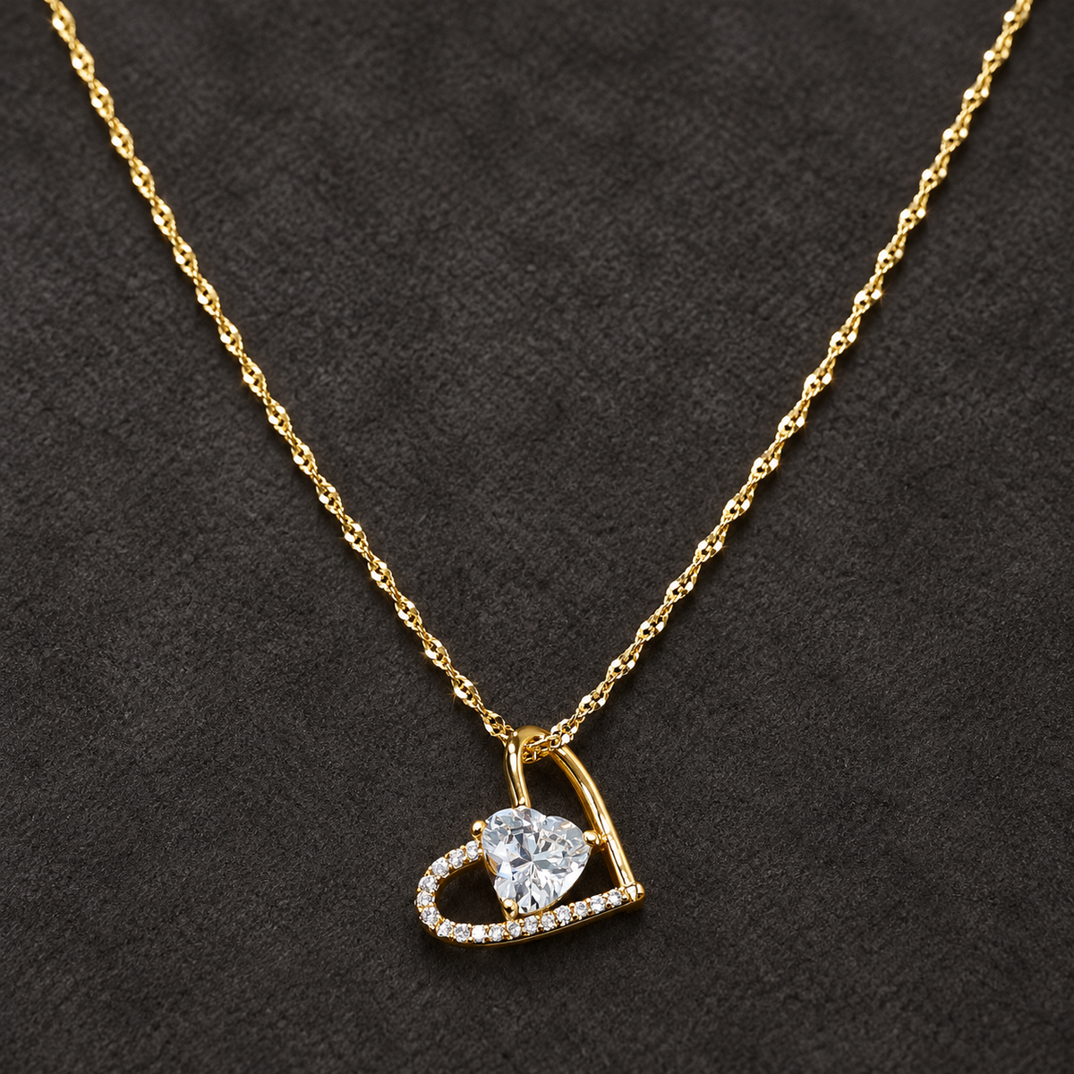 Gold-tone 316L stainless steel heart pendant necklace with a clear crystal heart centre and pavé outline on a twisted chain