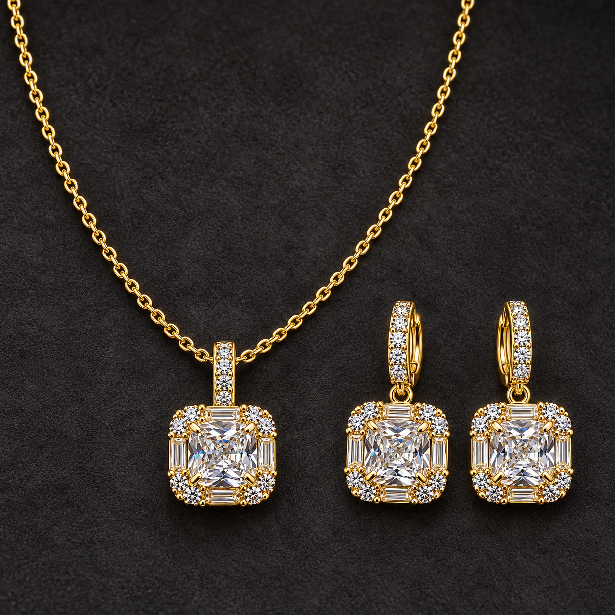 Gold-tone 316L stainless steel necklace and earring set with a cushion-cut crystal pendant and baguette-edged halo, earrings shown as a pair