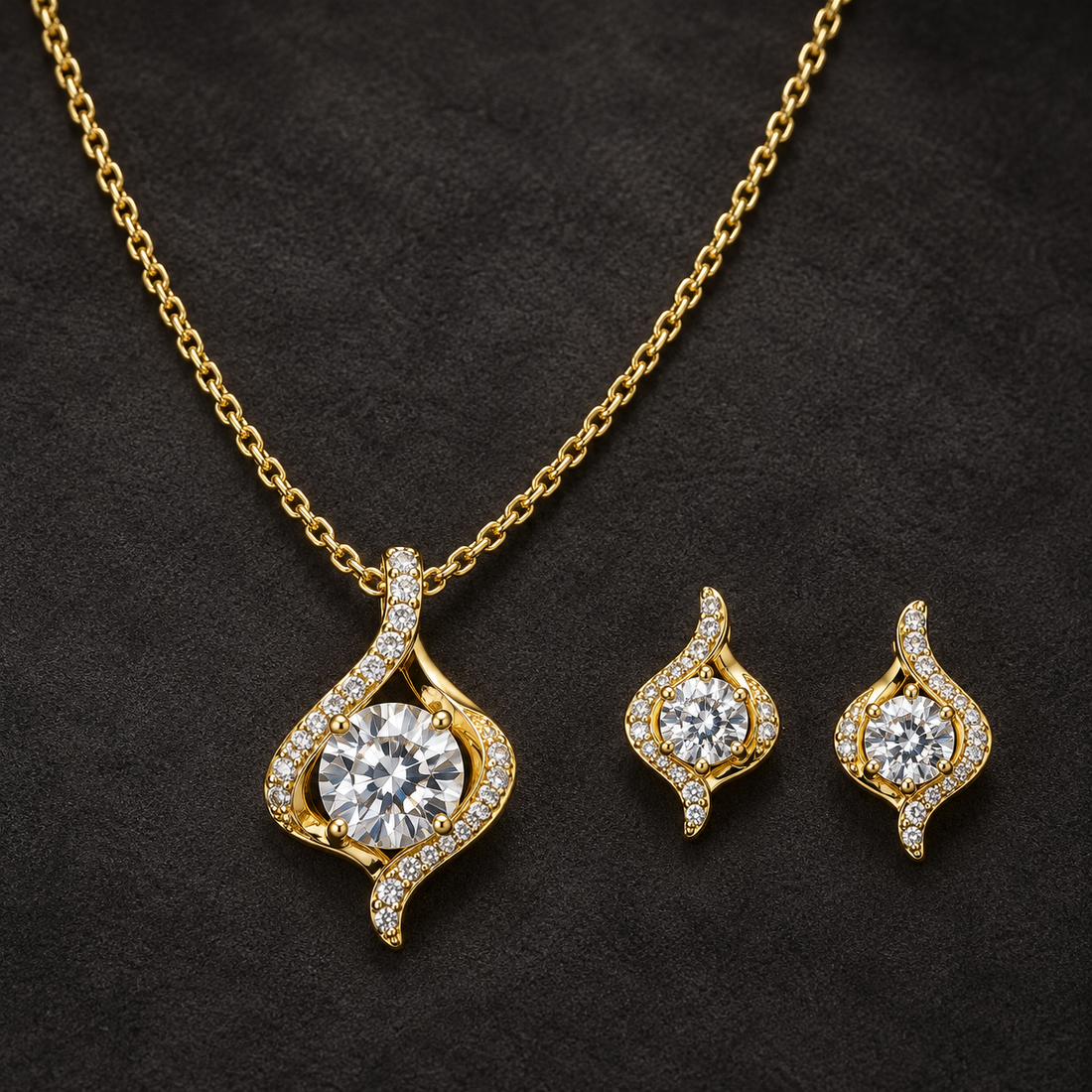 Gold-tone 316L stainless steel necklace and earring set with a flame-shaped pendant set with clear round stones, on a dark background