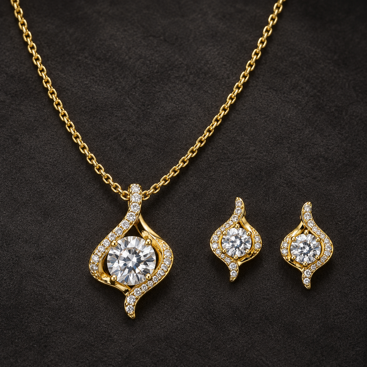 Gold-tone 316L stainless steel necklace and earring set with a flame-shaped pendant set with clear round stones, on a dark background