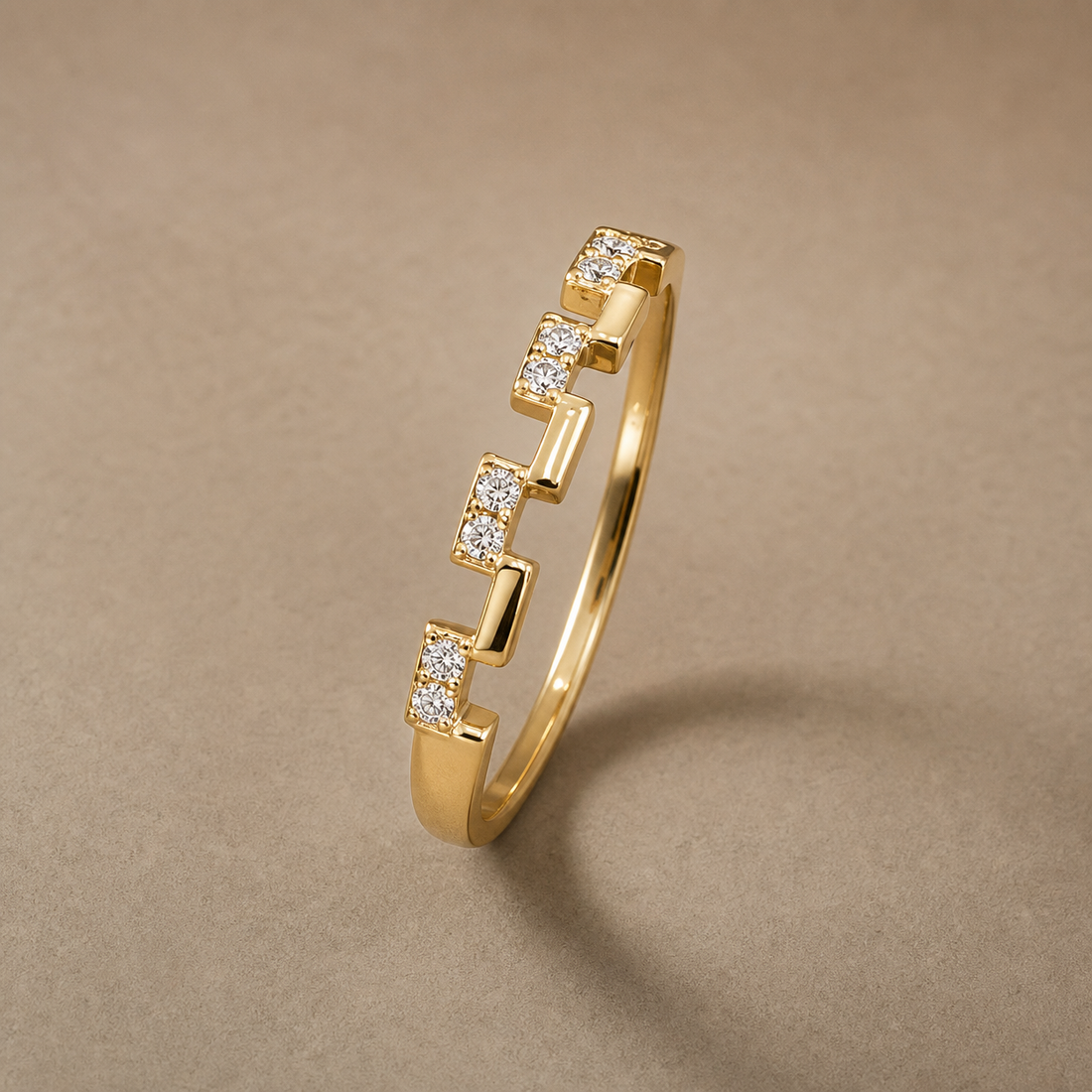 Gold-tone 304 stainless steel stacking ring with a stepped block design set with small clear stones, shown at an angle